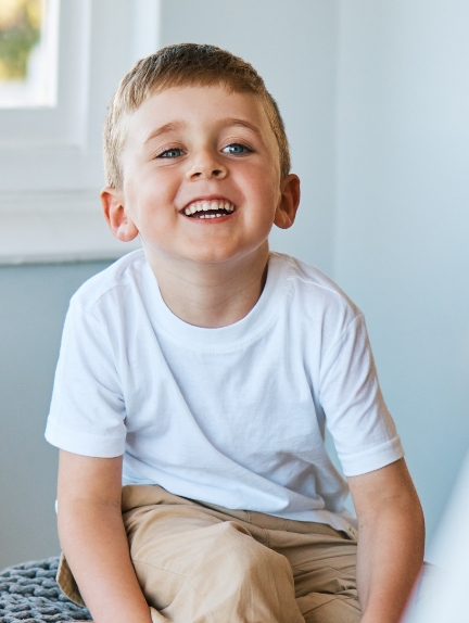 Young boy smiling in doctors office