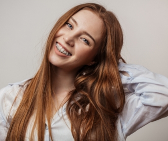 Young woman smiling with clear braces
