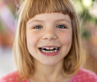 Young girl grinning with braces