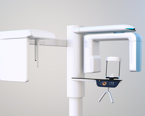 Cone beam C T scanner standing against white wall