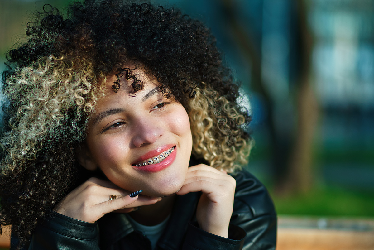 Beautiful woman with braces smiling for a photo.