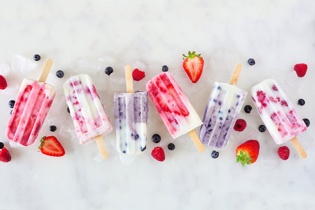 Group of assorted berry fruit yogurt ice pops.