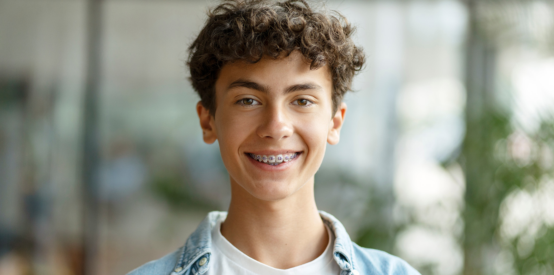 Closeup portrait of smiling school boy wearing braces