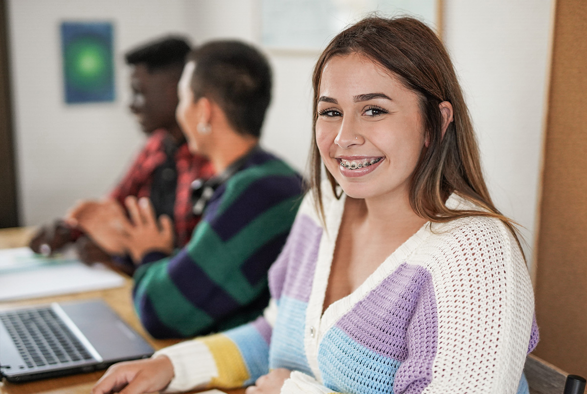 Young female student smiling on camera with braces