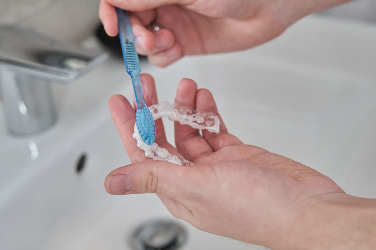 Cleaning clear aligners as part of an Invisalign school routine